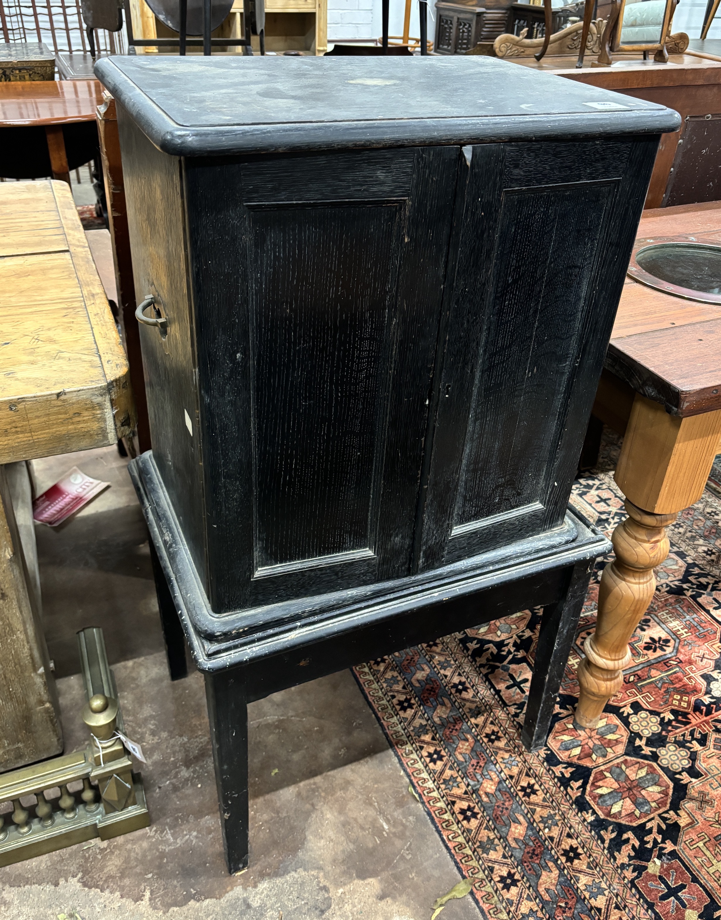 An Edwardian ebonised oak canteen cabinet on associated stand, width 64cm, depth 49cm, height 113cm